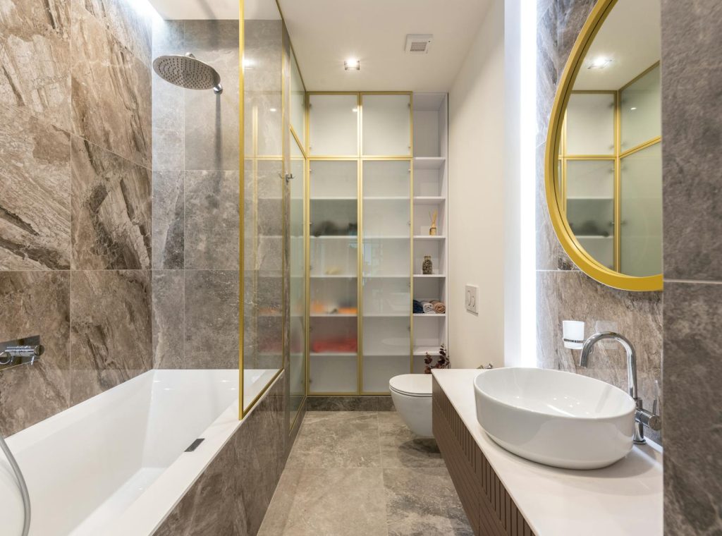 Modern light bathroom with a white vanity, large mirror, and bathtub