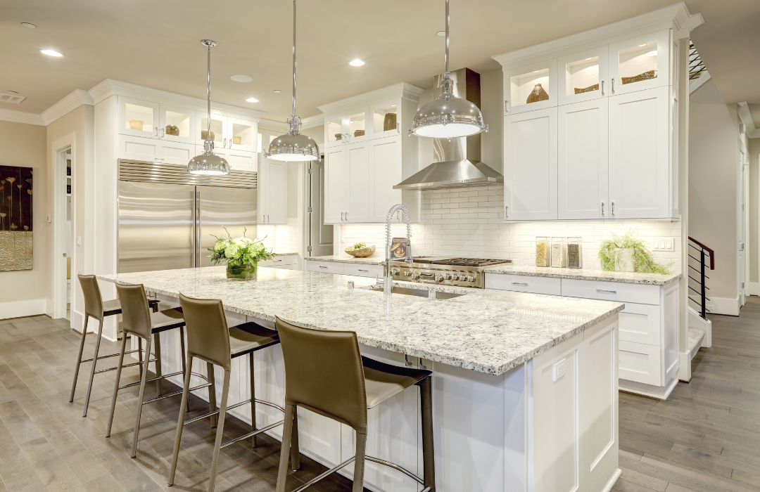 Kitchen with stone countertops and integrated appliances in quiet luxury style